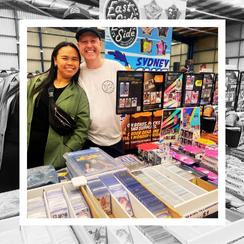 Stallholders with trading cards on display for sale